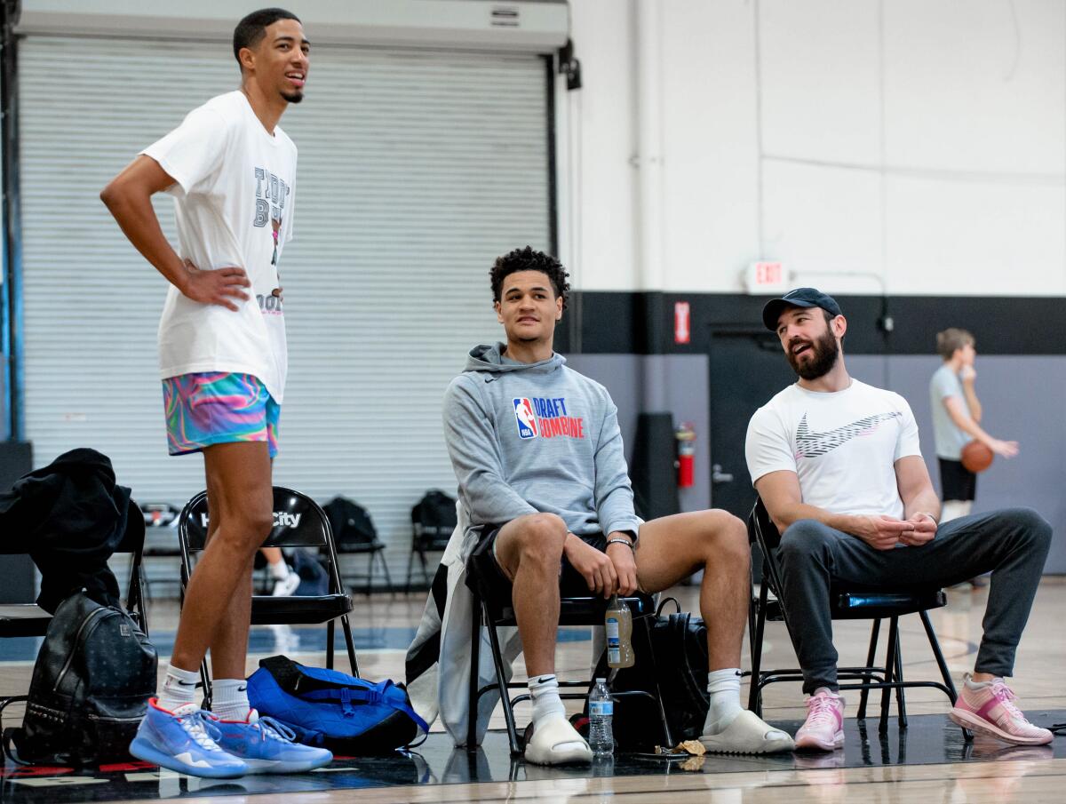 Tyrese Haliburton (left), Josh Green (center) and Dave Spahn take a break during a training session in Las Vegas.