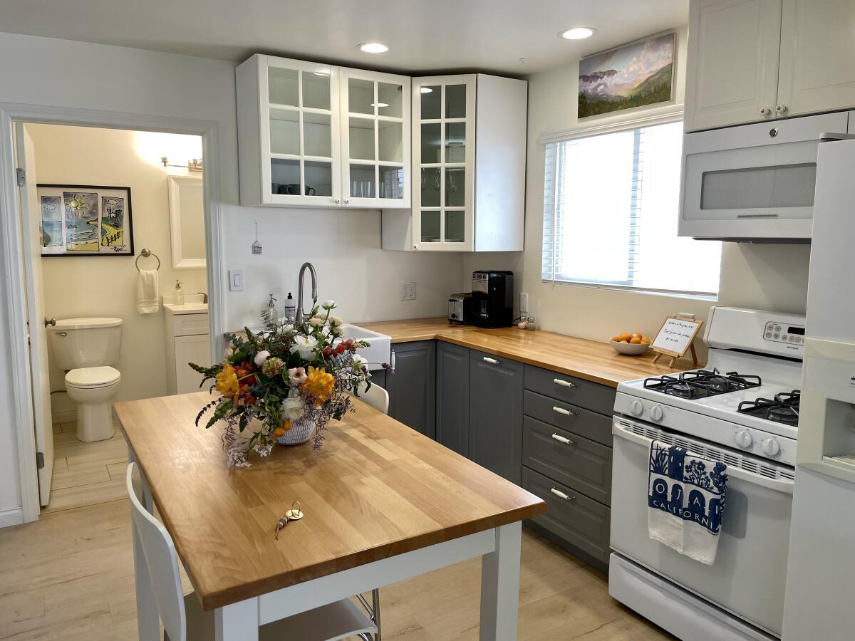 A kitchen with flowers on a center table