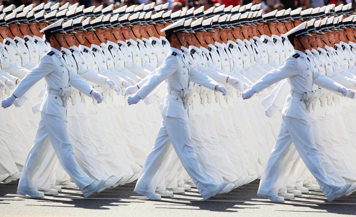 In a 2009 file photo, Chinese People's Liberation Army sailors march pass Tiananmen Square during the celebration of the 60th anniversary of the founding of the People's Republic of China.