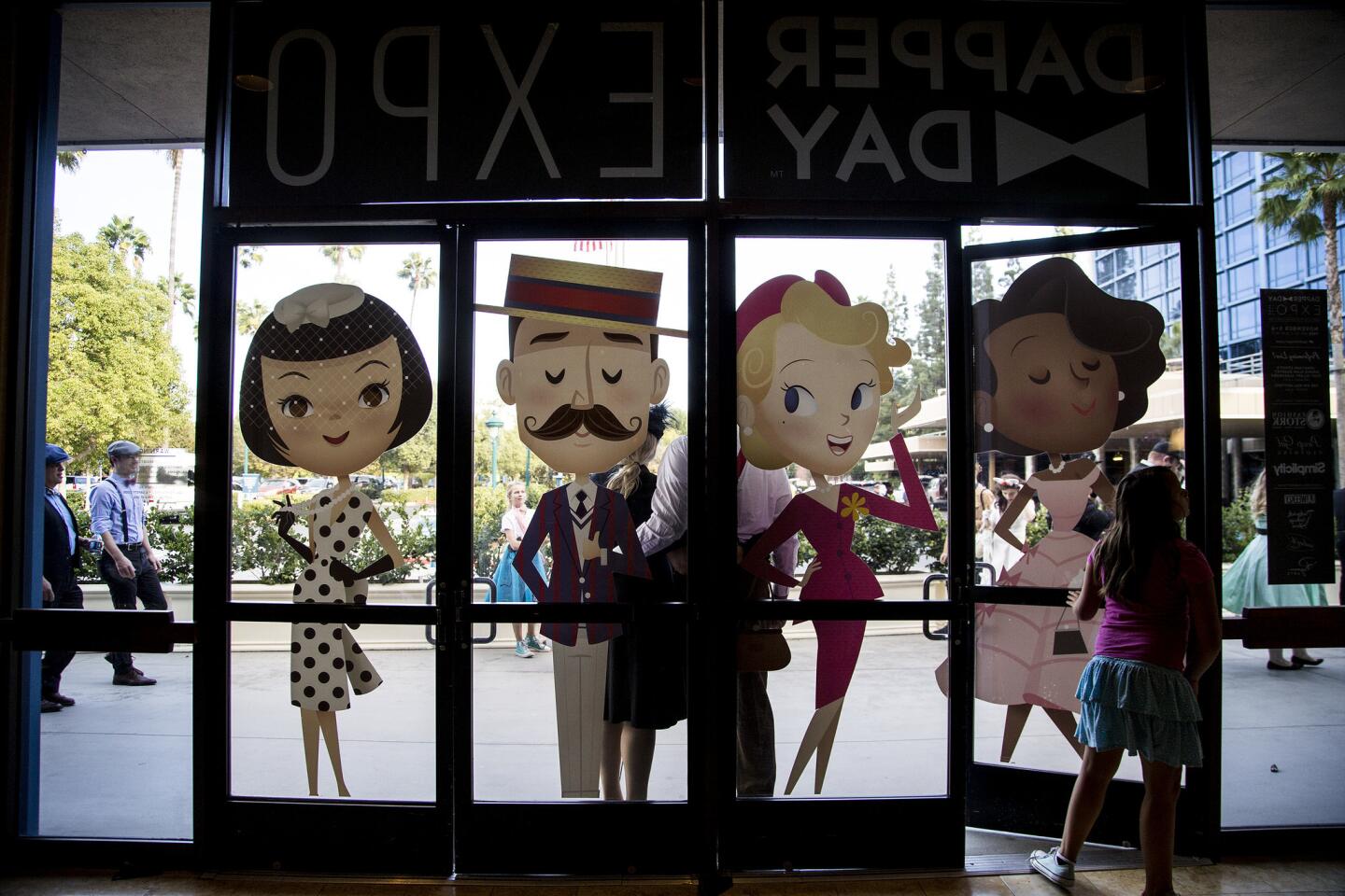 Dapper figures adorn the entrance during the Dapper Day Expo at the Disneyland Hotel.