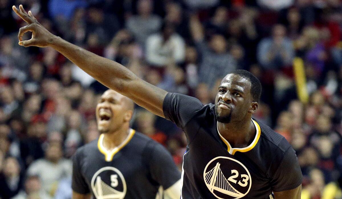 Warriors forward Draymond Green (23) celebrates after sinking a three-pointer against the Bulls on Saturday.