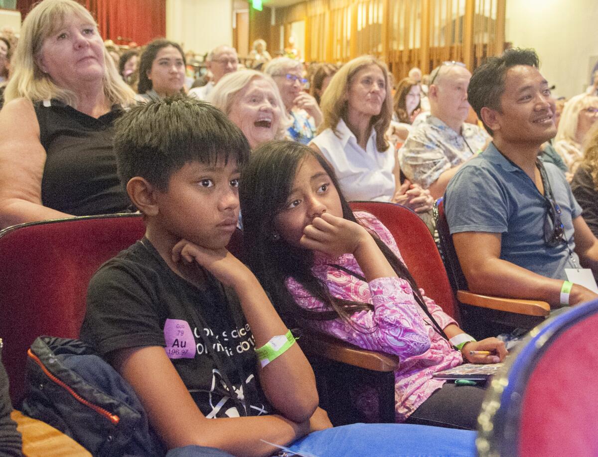 Winston and Betty Ordona, both 11, with Dad Michael Ordona, listen to Chelsea Clinton during the Los Angeles Times Festival of Books on Sunday at USC.