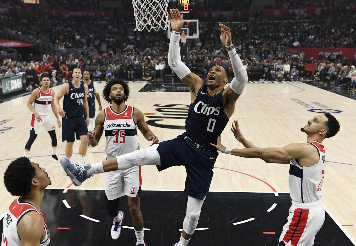 Clippers guard Russell Westbrook tries to score over Washington's Jordan Poole, bottom left, and and Landry Shamet.