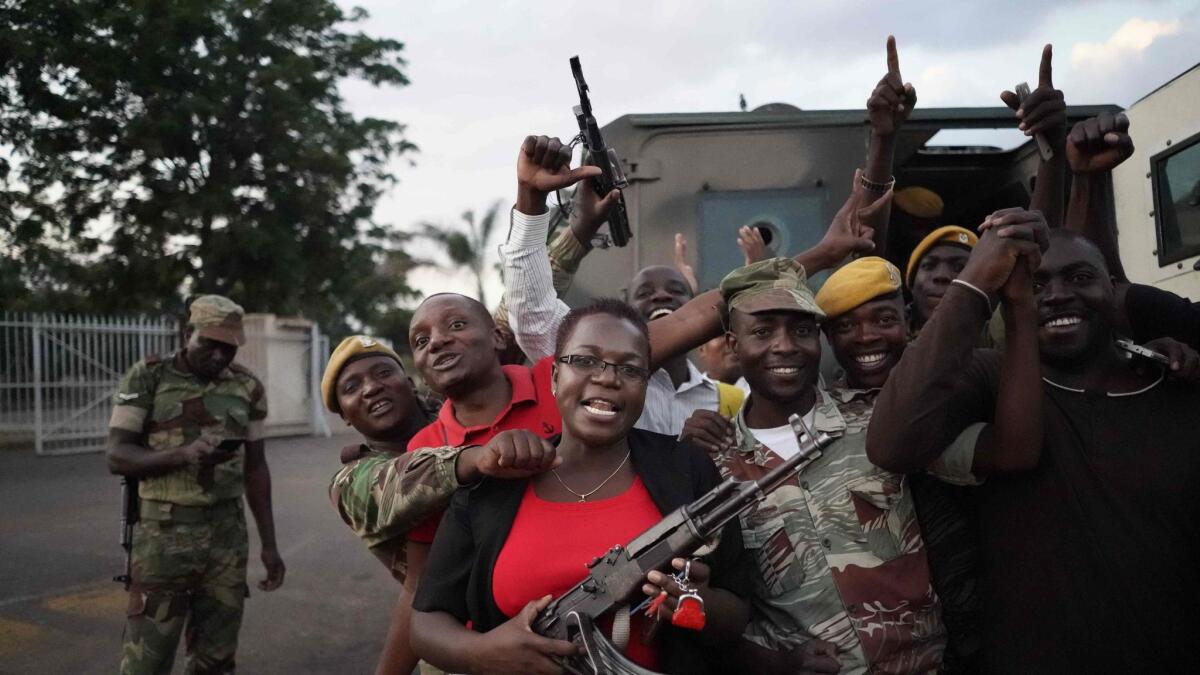 Civilians and soldiers celebrate after the resignation of Zimbabwe's president on Nov. 21, 2017, in Harare.