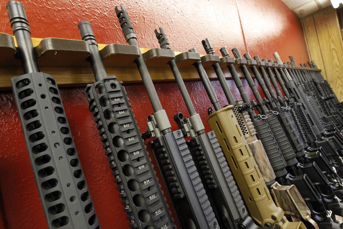 FILE - In this July 20, 2012, photo, a row of different AR-15 style rifles are displayed for sale at the Firing-Line indoor range and gun shop in Aurora, Colo. A warning about possible violence last year involving the 18-year-old now being held in the Buffalo, New York, supermarket shooting is turning attention to New York's "red flag" law. (AP Photo/Alex Brandon, File)