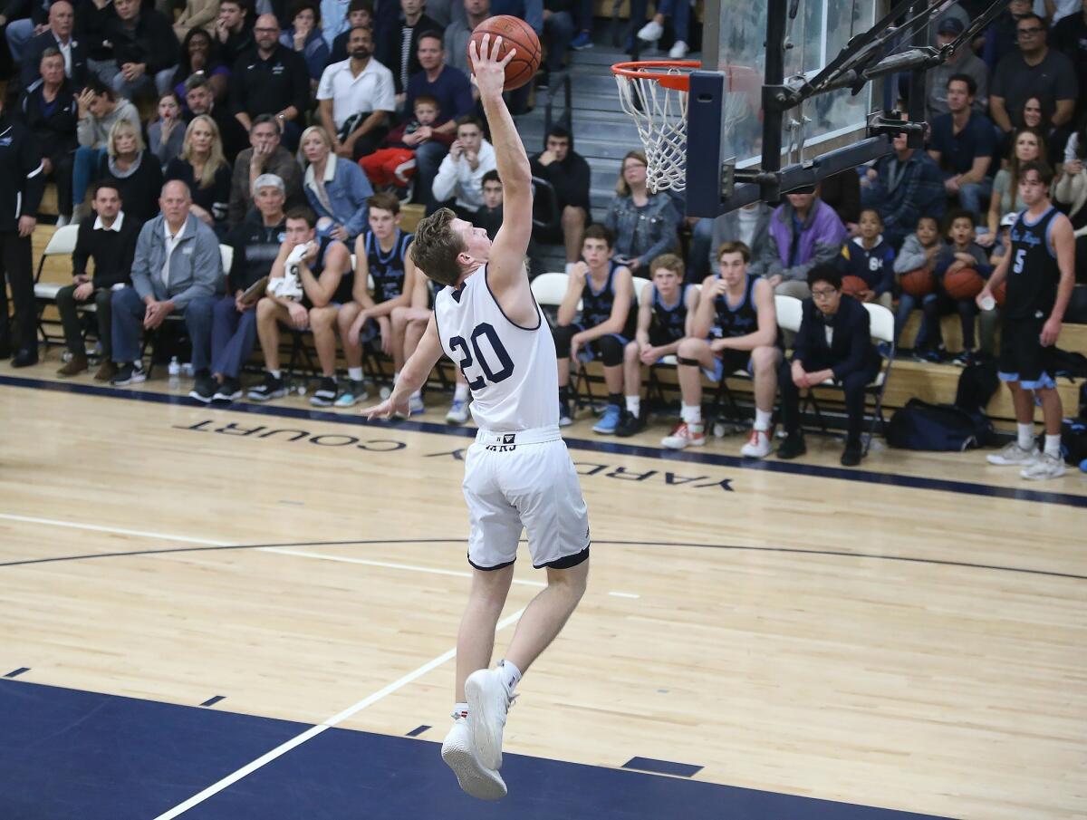 Newport Harbor point guard Sam Barela dunks it after a steal in a Surf League game against Corona del Mar at home on Jan. 18.