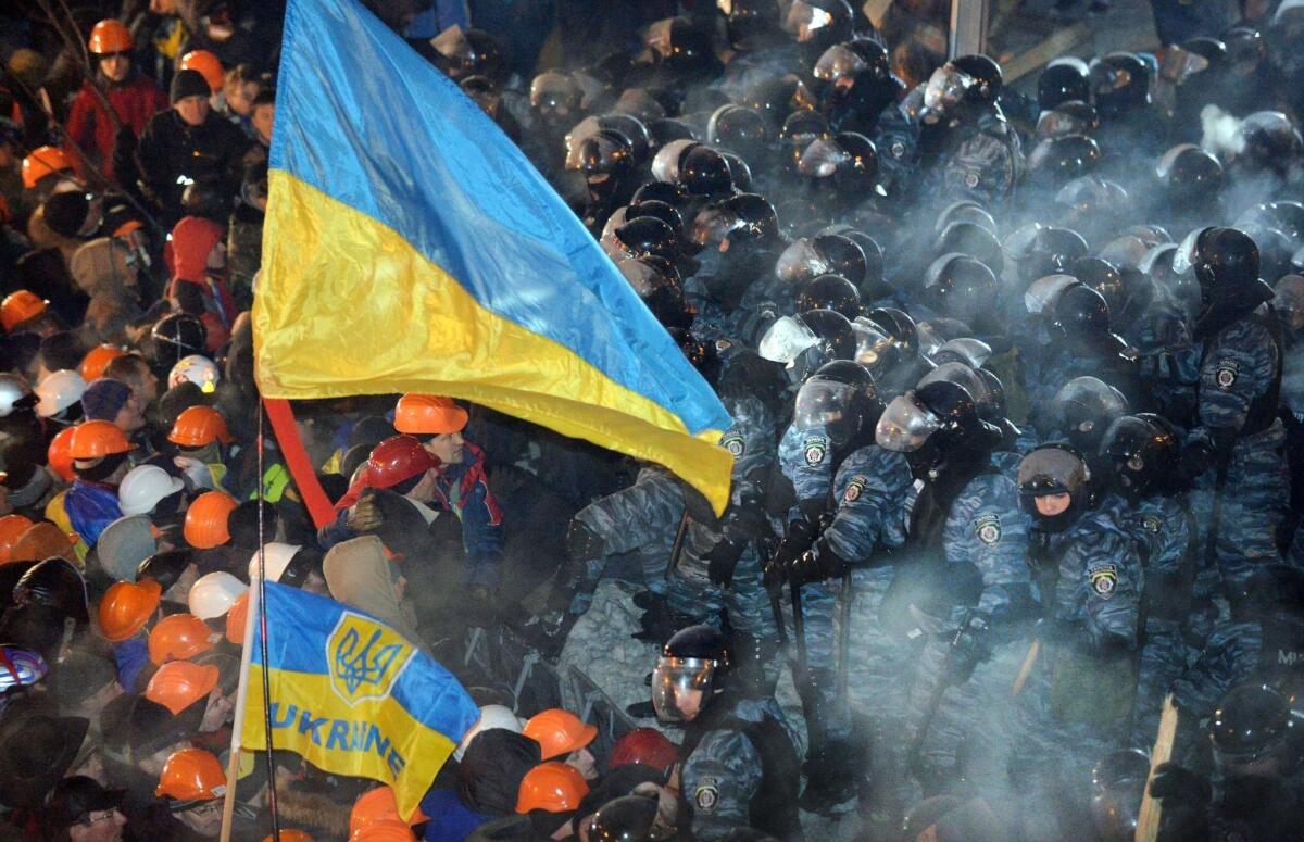 Riot police clash with protesters in Independence Square in Kiev.