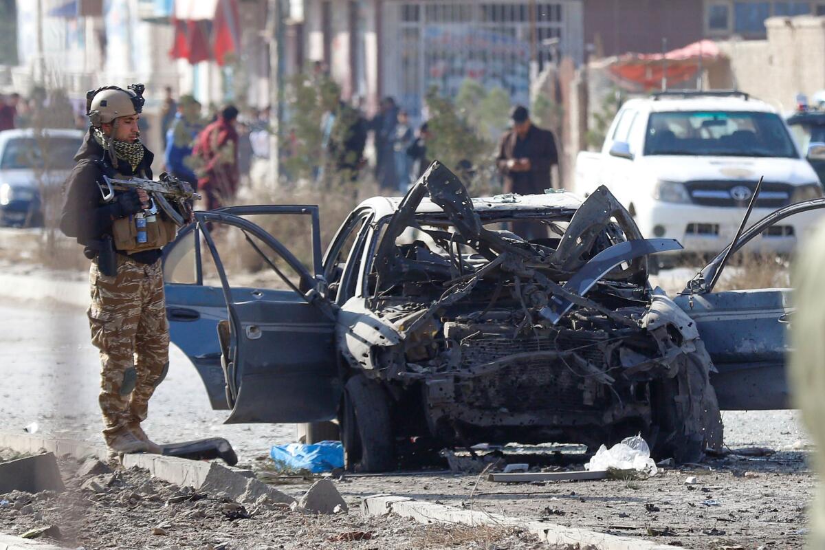 A soldier stands next to the site of a suicide attack in Kabul, Afghanistan, on Nov. 13, 2019.