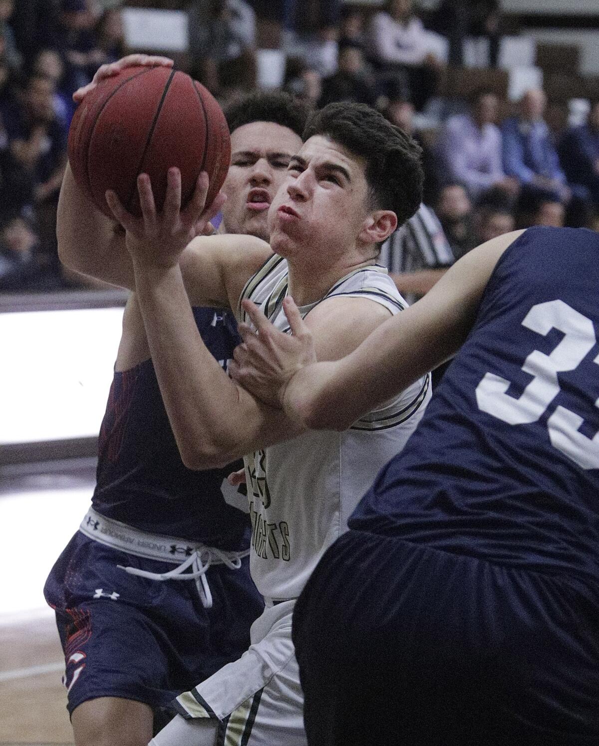 St. Francis' Jason Gallant drives early in the game between Chaminade's Keith Higgins, Jr. and Keith Higgins, Jr. just before scoring and being fouled at a Mission League semifinal boys' basketball game at Crespi Carmelite High School in Encino on Wednesday, February 5, 2020.