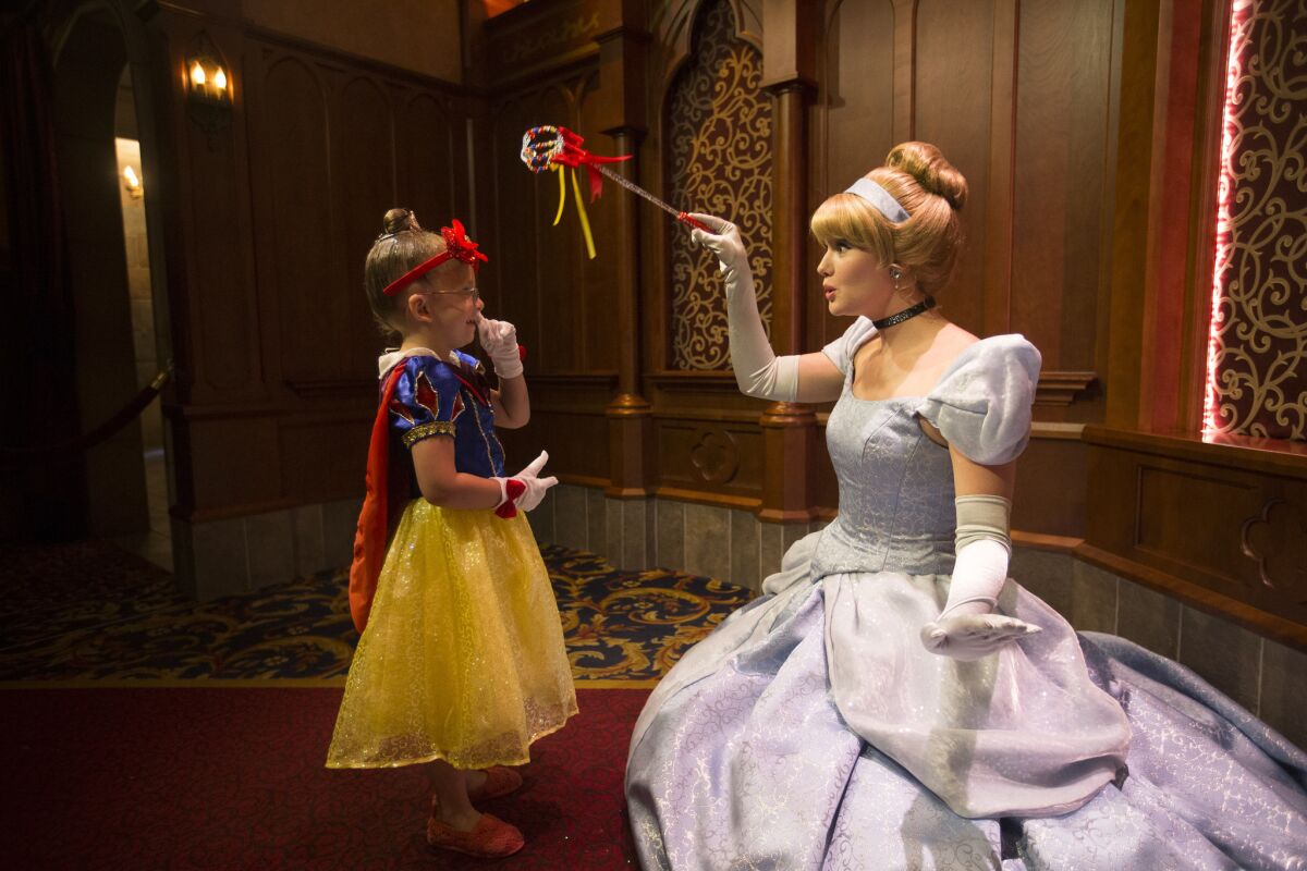 Cloie Lowry, 4, of Rock Springs, Wyo., meets Cinderella in Fantasy Faire Royal Hall, where kids meet Disney princesses.