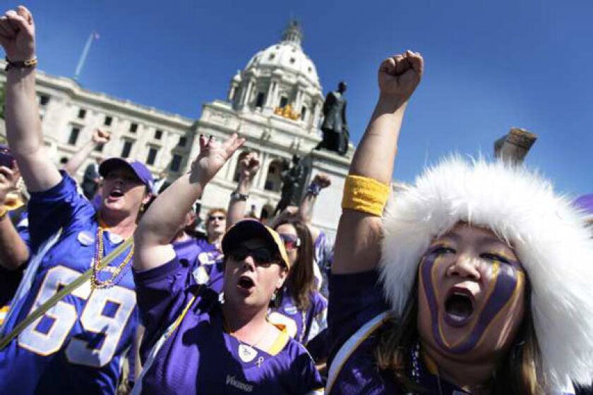 Vikings fans gather outside of the state Capitol in St. Paul, Minn., to show their support for a new stadium.