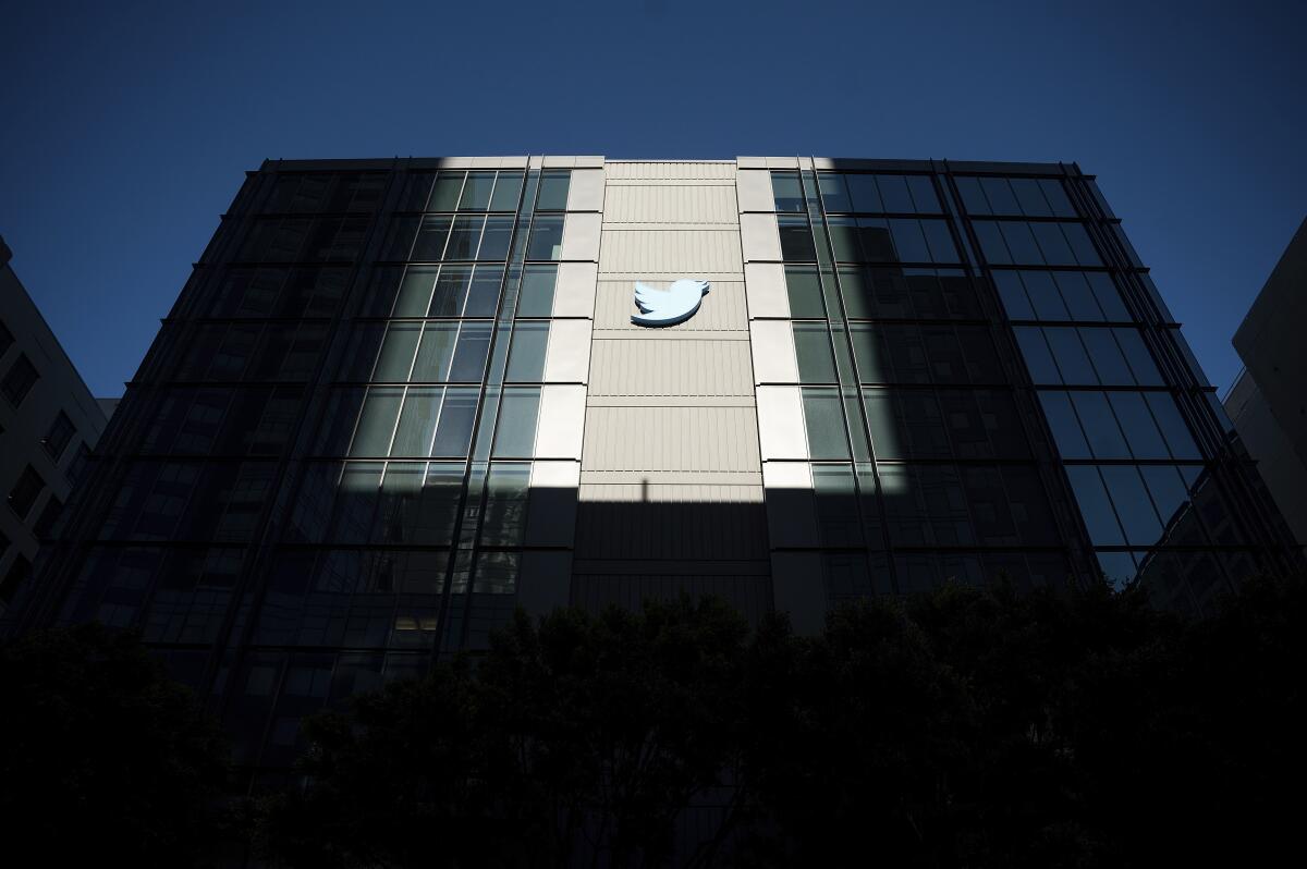 A Twitter logo hangs outside the company's office.
