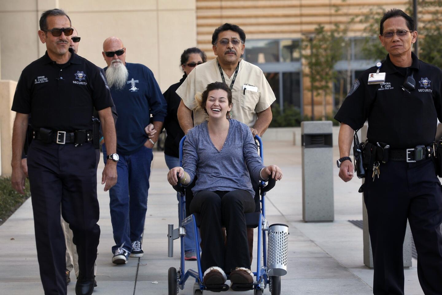 Rescued hiker Kyndall Jack, 18, is wheeled to address the media during a news conference in front of UC Irvine Medical Center.