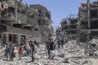 Palestinians walk through the destruction in the wake of an Israeli air and ground offensive in Jebaliya, northern Gaza Strip, Thursday, May 30, 2024. (AP Photo/Enas Rami)