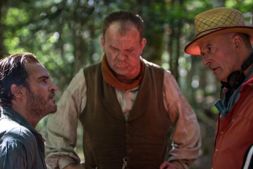 (L to R) Actor Joaquin Phoenix, actor John C. Reilly and director Jacques Audiard on the set of THE SISTERS BROTHERS, an Annapurna Pictures release. Credit : Magali Bragard / Annapurna Pictures