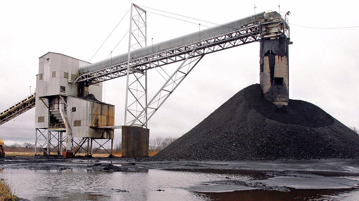 A conveyor belt moves underground mined coal to the surface at a Peabody Energy facility in Illinois. Peabody's 2016 bankruptcy filing may allow it to wriggle free of paying for the consequences of climate change.