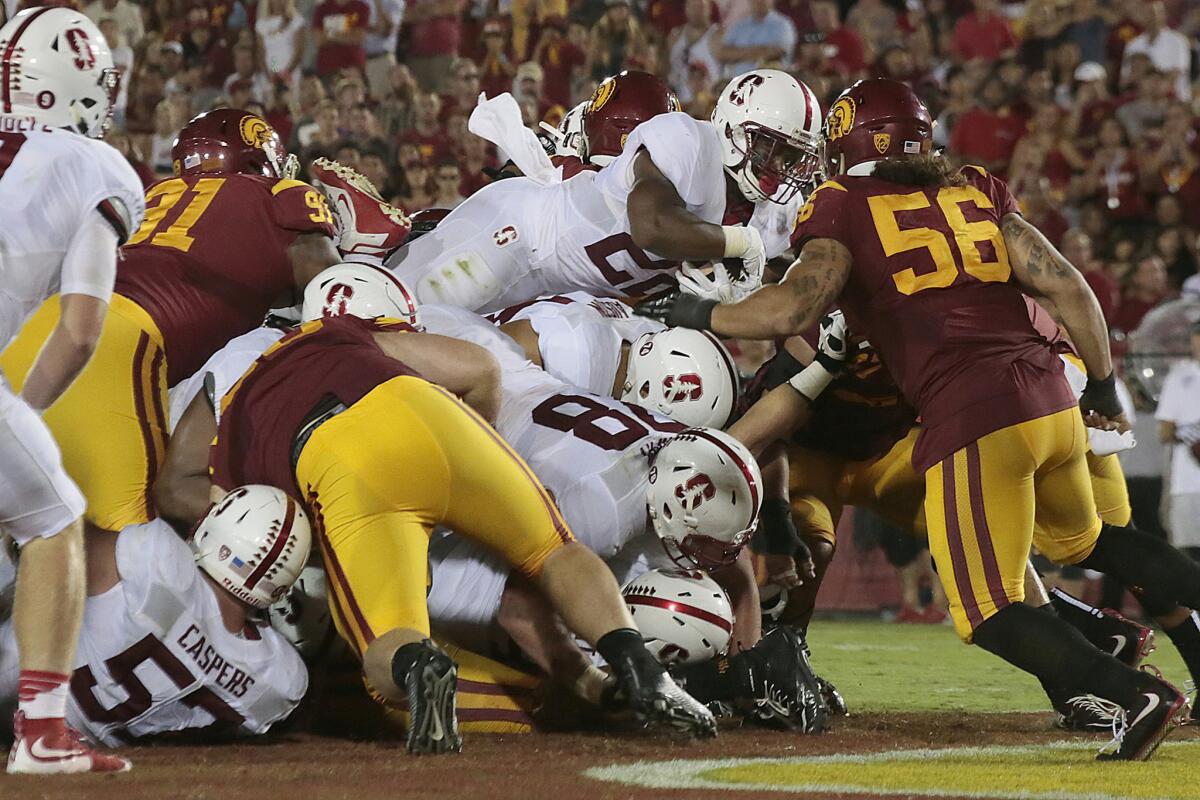 Cardinal running back Remound Wright leaps over the line to score against USC in the fourth quarter.