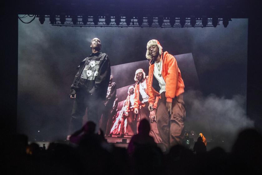 LOS ANGELES, CALIF. -- SUNDAY, NOVEMBER 10, 2019: ASAP Rocky, left, is seen performing on a large television screen as he performs as one of three mystery guests of Tyler, The Creator, shown at right, on the final day of Camp Flog Gnaw Carnival at Dodger Stadium parking lot in Los Angeles, Calif., on Nov. 10, 2019. (Allen J. Schaben / Los Angeles Times)