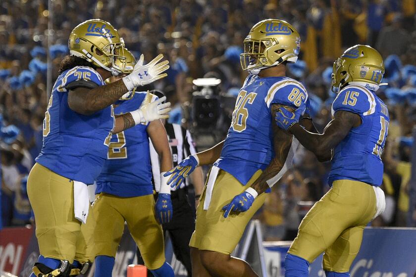 UCLA tight end Devin Asiasi, center, celebrates his catch for a touchdown during the second half of an NCAA college football game against Colorado in Los Angeles, Saturday, Nov. 2, 2019. UCLA won 31-14. (AP Photo/Kelvin Kuo)