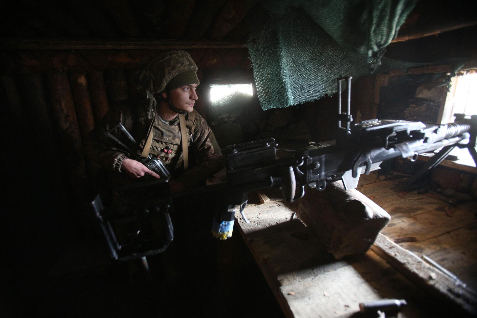 A Ukrainian soldier keeps watch on the front line with Russia-backed separatists in Luhansk, Ukraine.