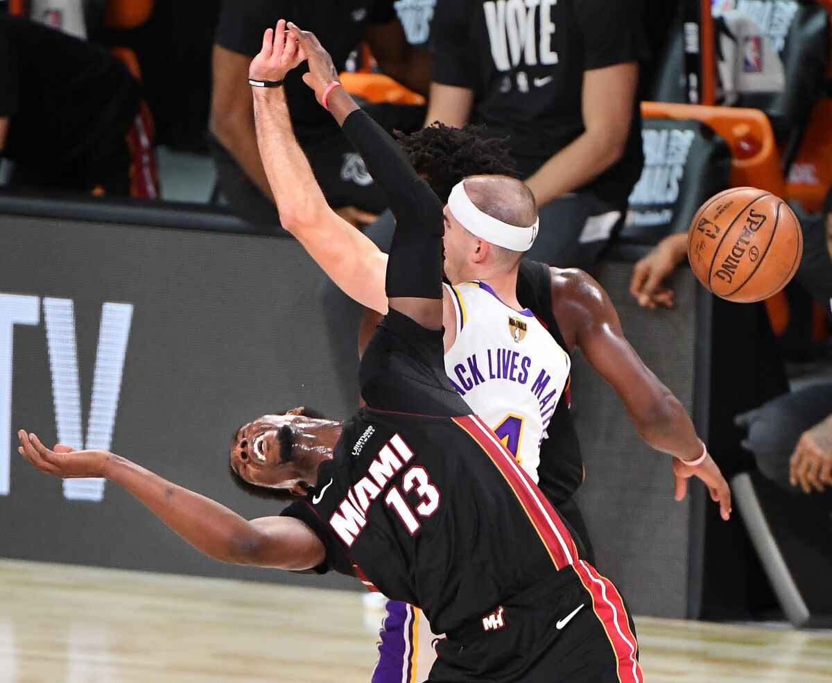 Lakers guard Alex Caruso fouls Heat center Bam Adebayo on a rebound during Game 6.