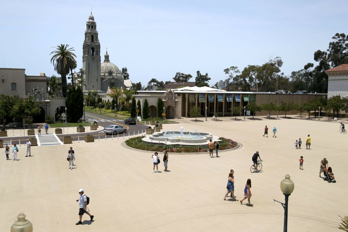 People walk across the Plaza de Panama, which is now closed to cars, at Balboa Park in San Diego.