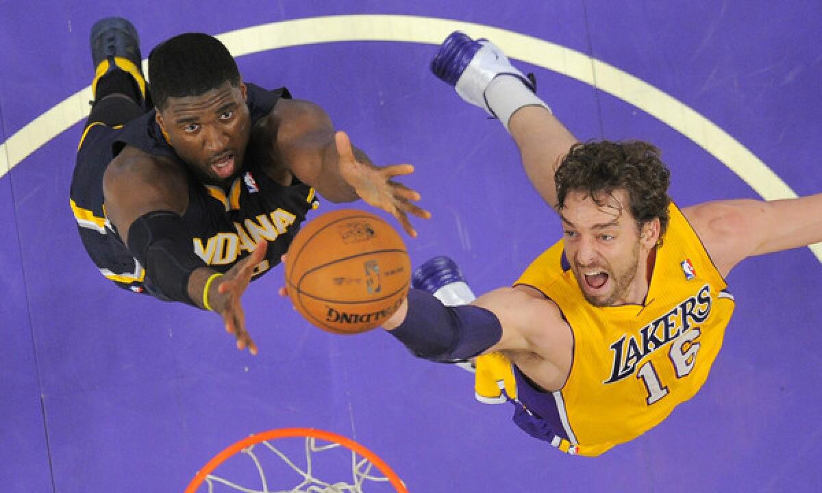 Lakers center Pau Gasol challenges Indiana Pacers center Roy Hibbert for a rebound.