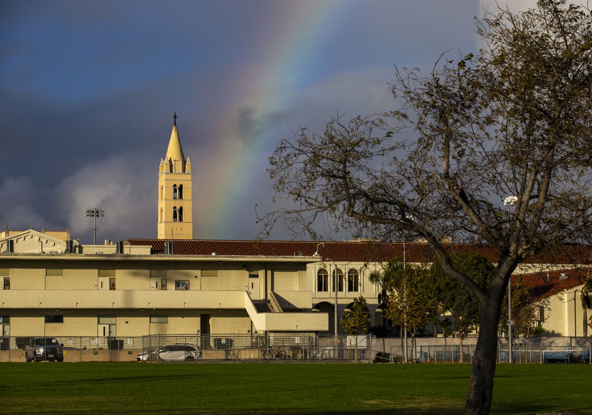 A rainbow is seen just over Huntington Beach High School following a storm on Tuesday.