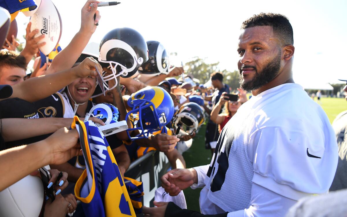 Rams defensive tackle Aaron Donald signs autographs at training camp on the campus of UC Irvine on Sunday.