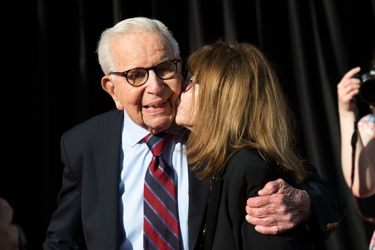 Producer Walter Mirisch gets a kiss on the cheek by actor Lee Grant.