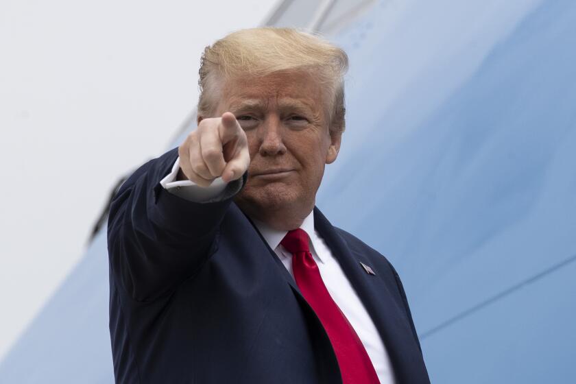 President Donald Trump points while boarding Air Force One as he departs Thursday, May 21, 2020, at Andrews Air Force Base, Md. Trump will visit a Ypsilanti, Mich., Ford plant that has been converted to making personal protection and medical equipment. (AP Photo/Alex Brandon)