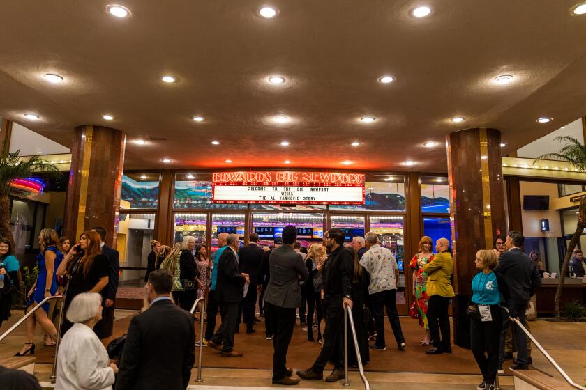 Audiences gather outside the theater during the Newport Beach Film Festival's opening night screening of "WEIRD: The Al Yankovic Story" at the Regal Edwards Big Newport on Thursday.