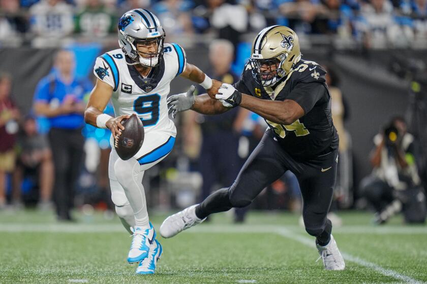 Carolina Panthers quarterback Bryce Young looks to pass under pressure from New Orleans Saints defensive end Cameron Jordan during the first half of an NFL football game Monday, Sept. 18, 2023, in Charlotte, N.C. (AP Photo/Rusty Jones)