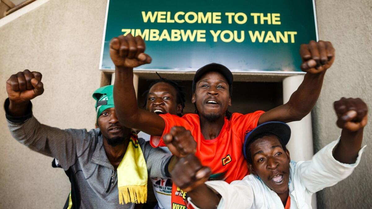 Supporters of Zimbabwe's ruling ZANU-PF party react Aug. 24 in Harare after the country's top court threw out an opposition bid to overturn presidential election results in favor of their candidate.