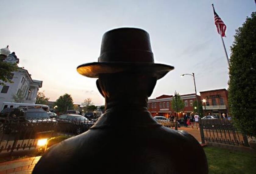 A statue of William Faulkner overlooks downtown Oxford, Miss. Faulkner's childhood home and burial spot are just a few short blocks apart, yet he somehow managed to encompass all of humanity from this small Southern town.