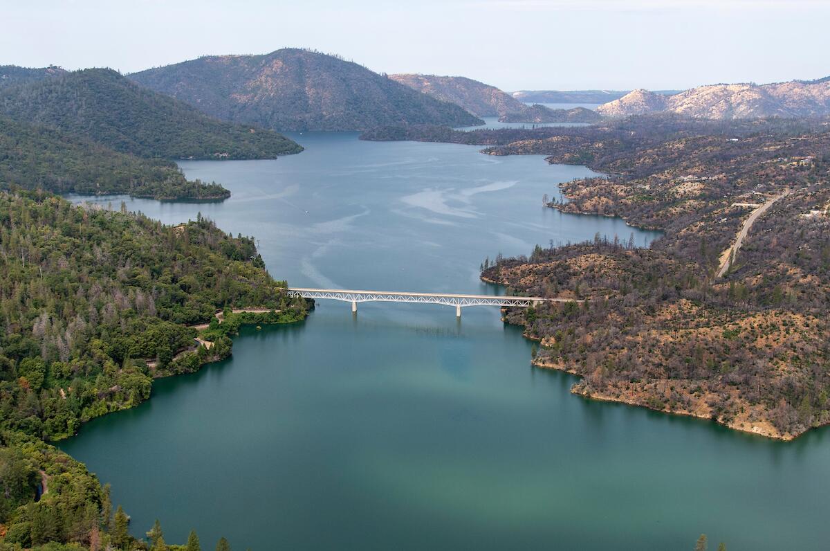 Aerial view of a full lake with a bridge crossing