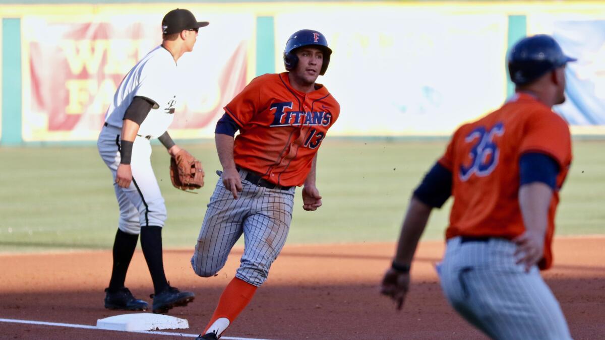 Cal State Fullerton shortstop Timmy Richards rounds third and scores a run against Long Beach State on March 23.