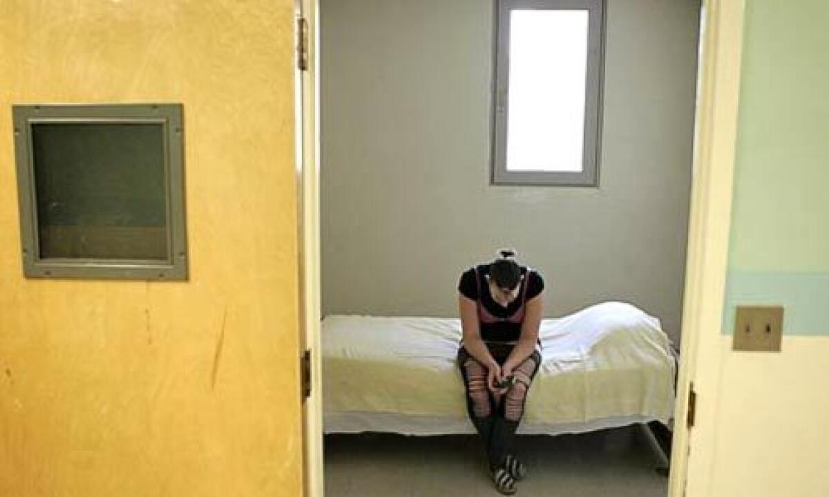 Tiffany sits in an isolation room at Metropolitan State Hospital,after complaining of feeling ill. "The reason why I have been self-medicating is because I have nothing," she said.