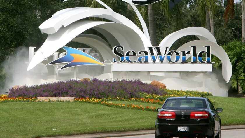The chief executive of SeaWorld Orlando's parent company is leaving the theme-park company.