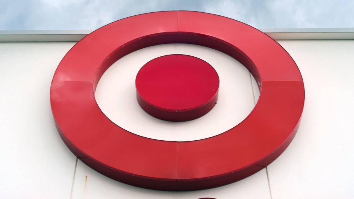 The cost of Target's massive overhaul, along with its pay increases, squeezed its fourth-quarter profit.