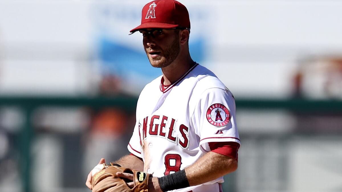 Angels second baseman Taylor Featherston can only watch Houston's Carlos Correa reach first base safely after fielding a ground ball that got stuck in the webbing of his glove in the ninth inning Sunday.