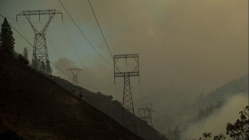 Power transmission lines crest a hilltop above Camp Creek Road, the point of origin of the Camp fire