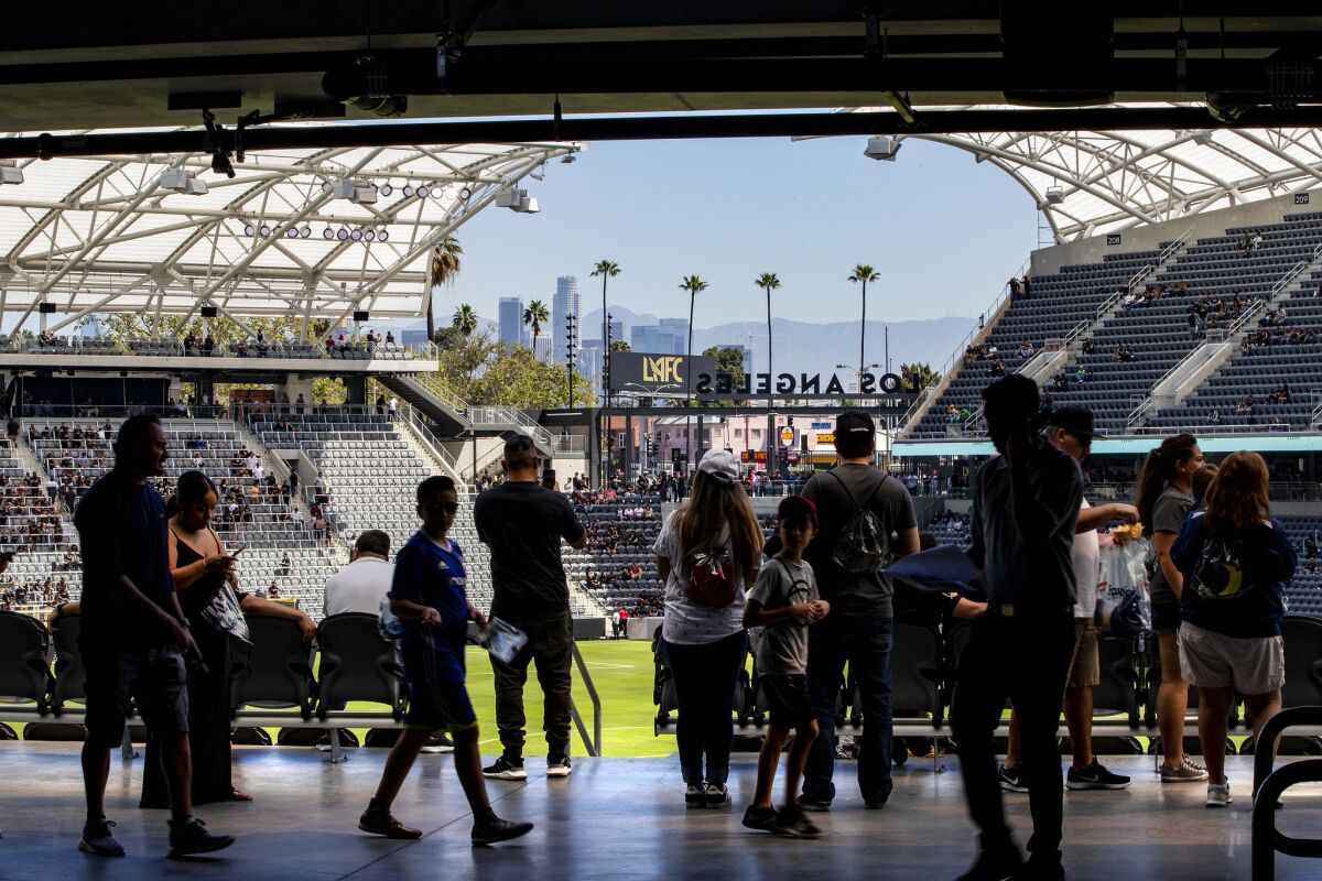 With a view of the downtown Los Angeles skyline in the background, hundreds of soccer fans check out the new Banc of California Stadium.