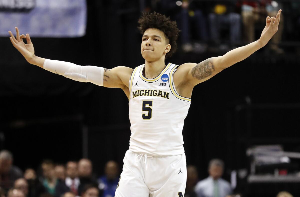 Michigan's D.J. Wilson celebrates after hitting a three-point basket against Oklahoma State.