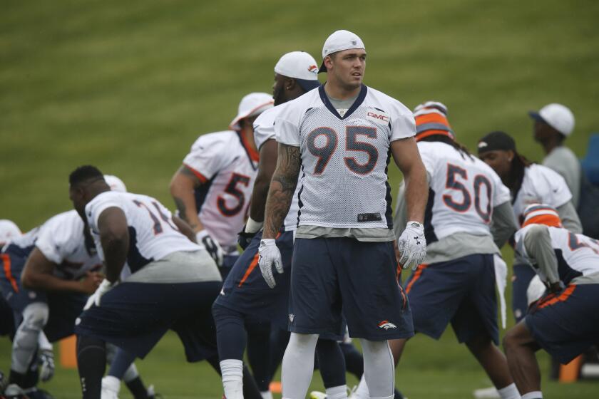 Denver defensive end Derek Wolfe takes part in team drills during the Broncos' June minicamp in Englewood, Colo.