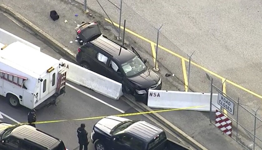 In this image made from video and provided by WUSA TV-9, authorities investigate the scene of a shooting outside the National Security Agency campus at Ft. Meade, Md., on Wednesday.