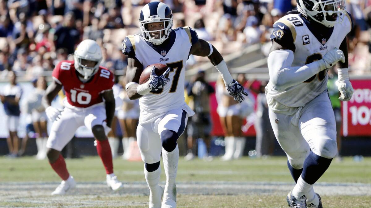 Rams defensive back Sam Shields, center, heads up filed after intercepting Arizona Cardinals quarterback Sam Bradford's pass in the second half at the Coliseum on Sept. 16.