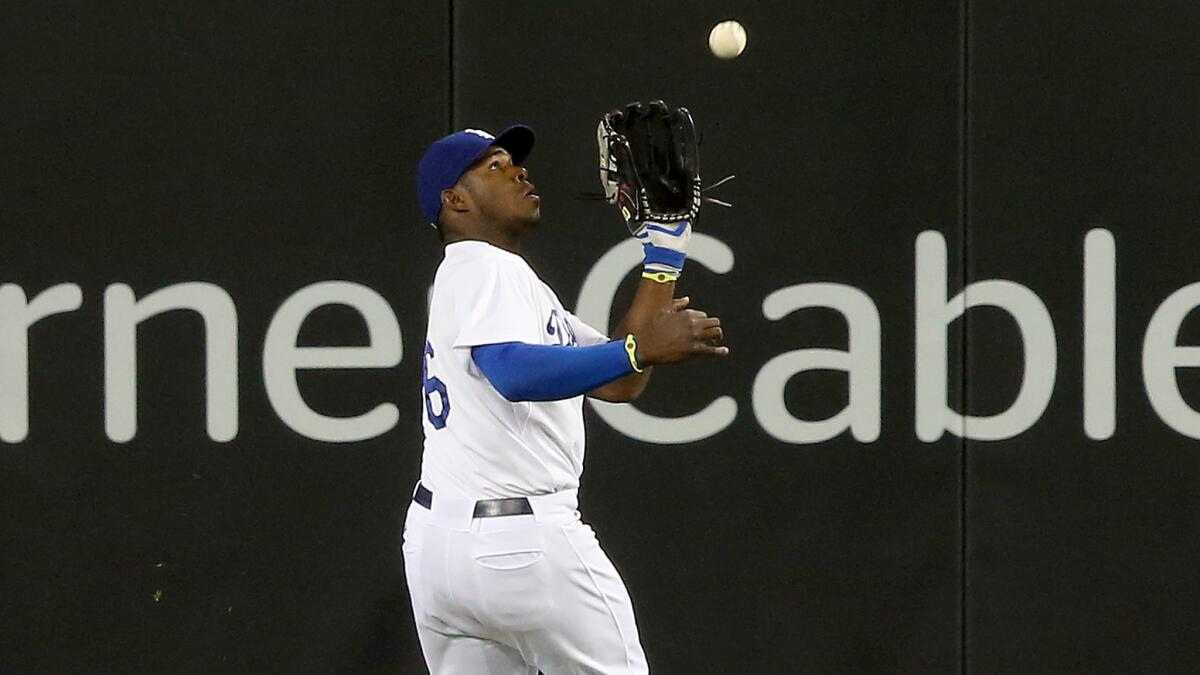 Dodgers center fielder Yasiel Puig makes a catch during the sixth inning of the team's 5-0 loss to the Angels on Monday.