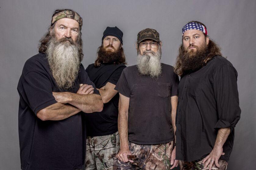 This 2012 photo released by A&E shows, from left, Phil Robertson, Jase Robertson, Si Robertson and Willie Robertson from the A&E series, "Duck Dynasty." The A&E channel says "Duck Dynasty" patriarch Phil Robertson is off the show indefinitely after condemning gays as sinners in a magazine interview.