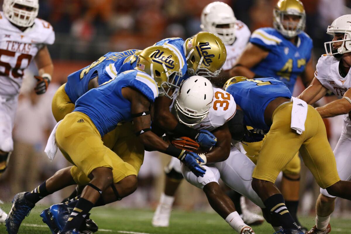 Texas tailback Johnathan Gray gets taken down by the UCLA defense on Sept. 13.